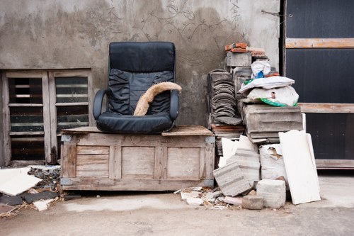 Crowded Brompton street with a skip placed legally on the sidewalk